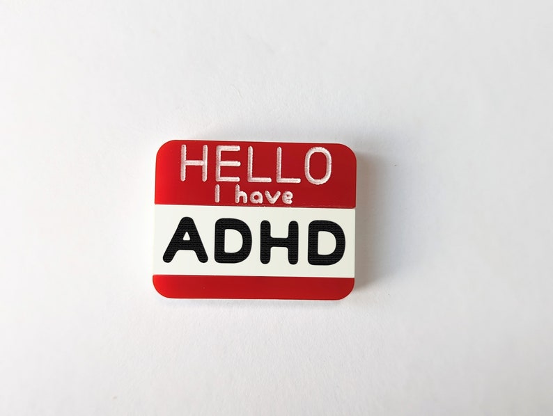 May include: Red name tag with white text that reads "HELLO I have ADHD".