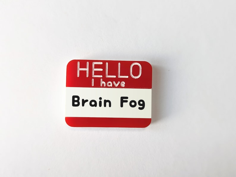 May include: Red name tag with white text that reads "HELLO I have Brain Fog".