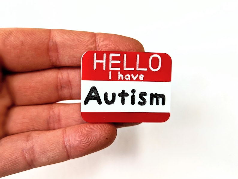 May include: Red name tag with white text that reads "Hello I have Autism".