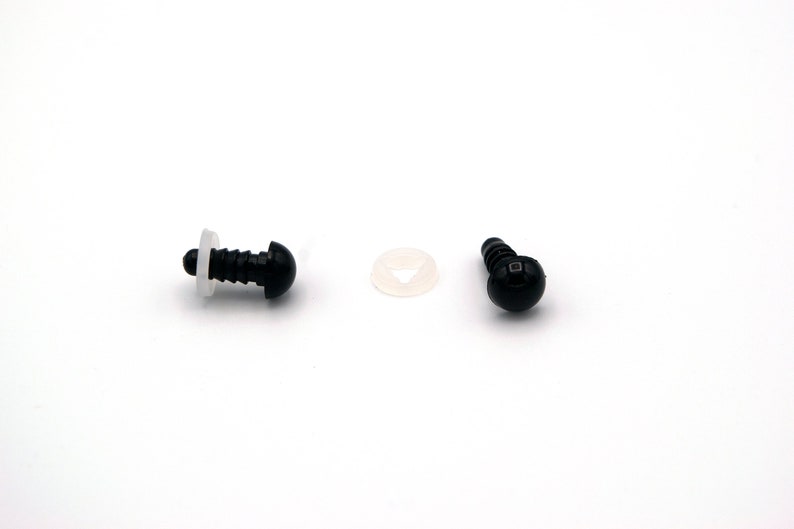 May include: Two black plastic safety eyes with a white plastic washer. The eyes are about 1 cm in diameter.