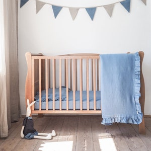 Linen crib bedding. Dusty blue crib bedding with a frill.