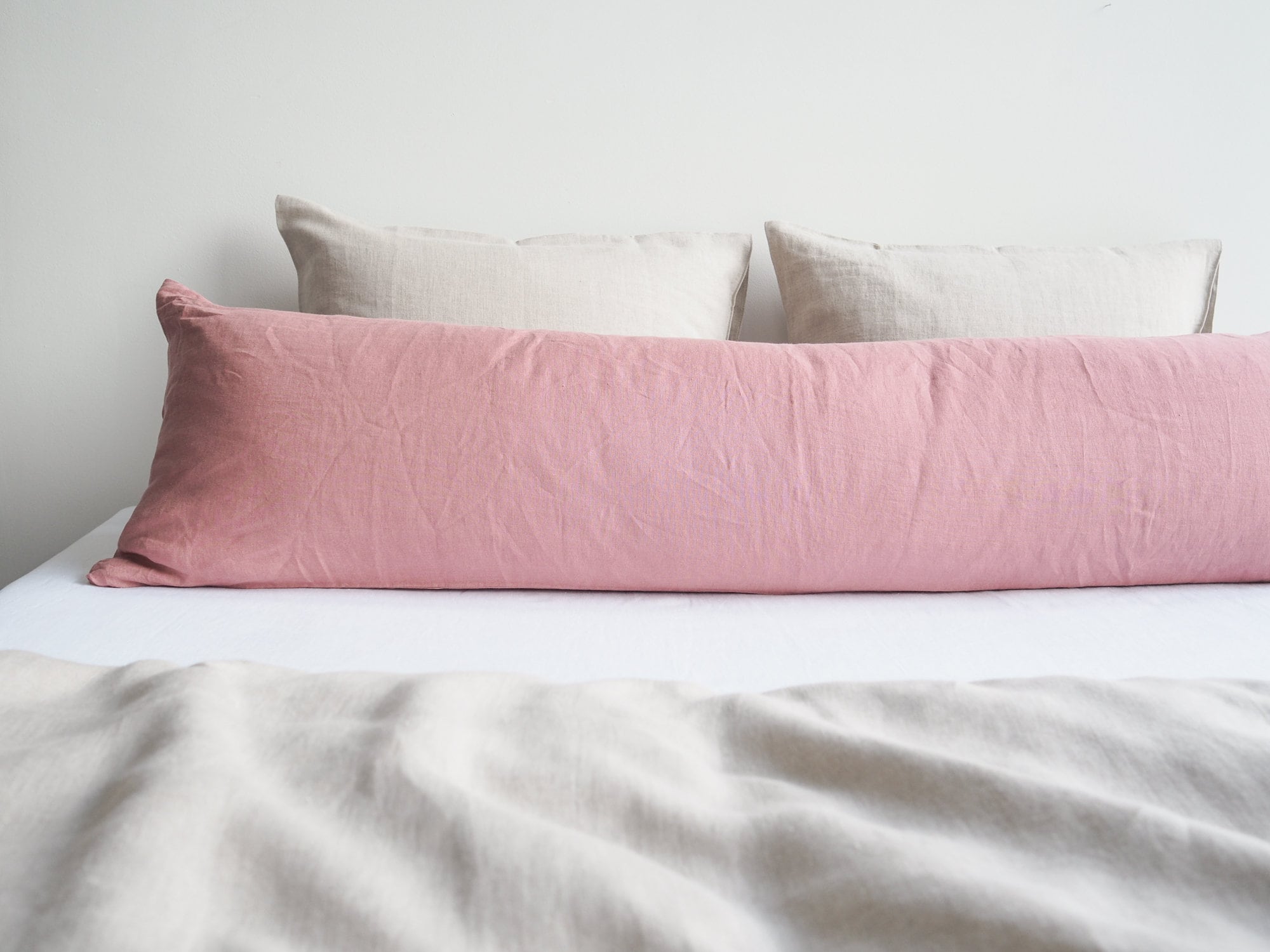 Linen body pillow pillowcase in dusty pink. Pillowcase for a long pillow made from 100% stonewashed linen.