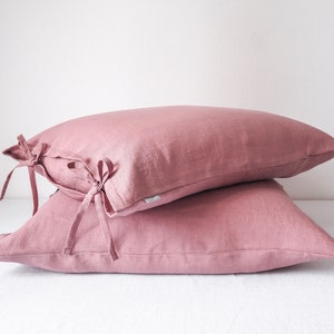 Dusty pink pillow cover tied with a bow. made of 100% european linen. stonewashed. handmade in poland.