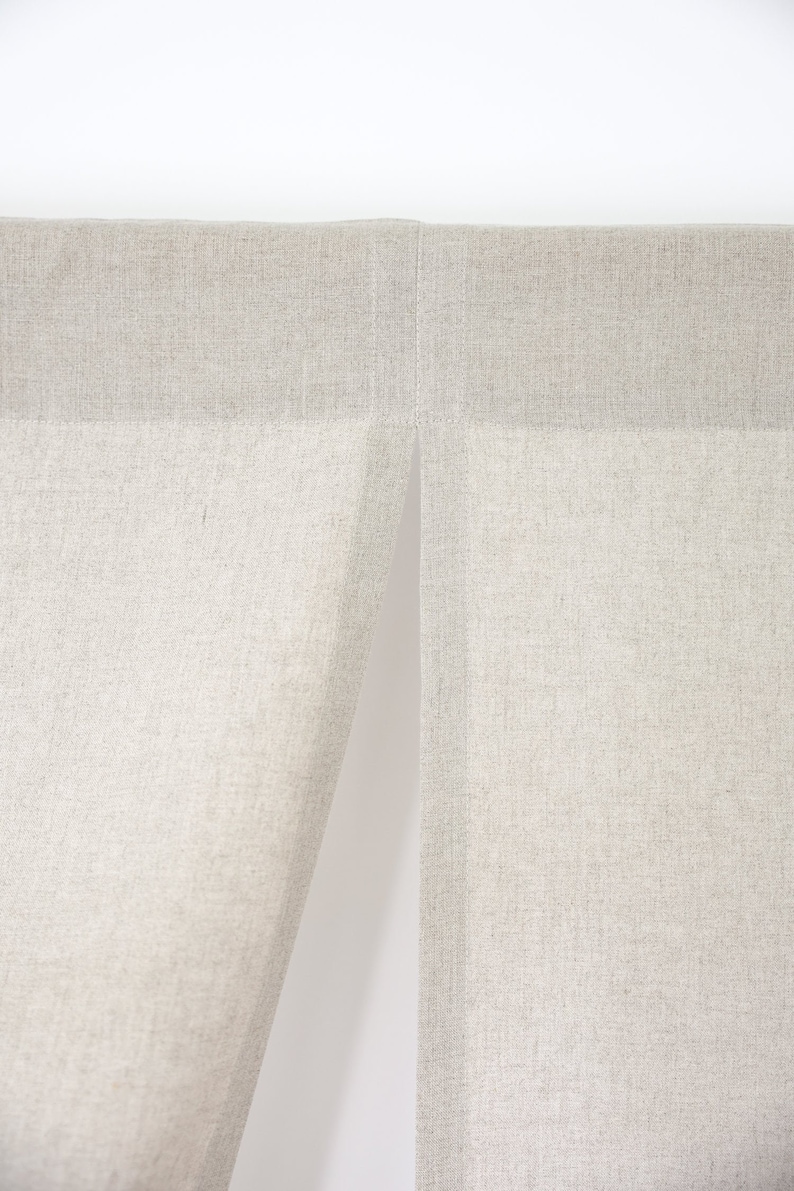 May include: Two panels of beige linen fabric with a seam down the centre.