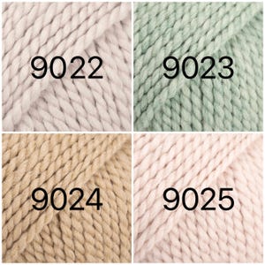 May include: Four skeins of yarn in different colors: light pink, light green, beige, and pink. The yarn is chunky and has a textured look. The skeins are labeled with the numbers 9022, 9023, 9024, and 9025.