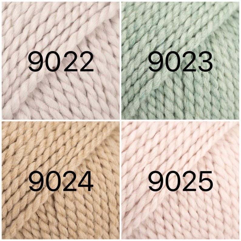 May include: Four skeins of yarn in different colors: light pink, light green, beige, and pink. The yarn is chunky and has a textured look. The skeins are labeled with the numbers 9022, 9023, 9024, and 9025.