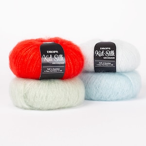 May include: Three balls of yarn in red, light green, and light blue. The yarn is labelled "DROPS Kid-Silk UNI COLOUR Soft & Lourious in Super Kid Mohair & Silk".