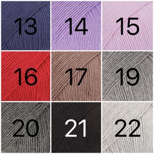 May include: Nine balls of yarn in different colors, numbered 13 through 22. The yarn is arranged in three rows of three balls each.