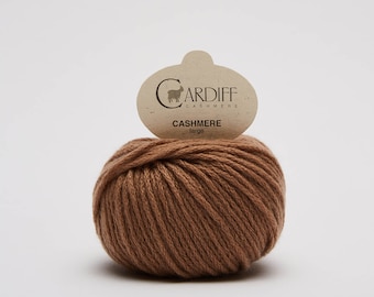 May include: A ball of brown cashmere yarn with a label that reads "CARDIFF CASHMERE" and "CASHMERE Large".