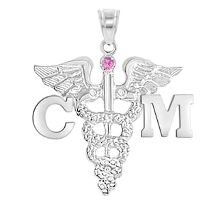 May include: Silver medical caduceus pendant with a pink gemstone and the letters "CM" on either side.