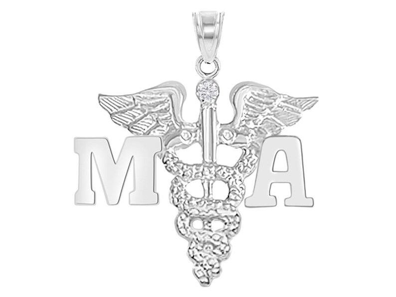 May include: Silver medical pendant necklace with a caduceus symbol and the letters "MA" on either side.