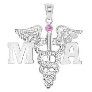May include: Silver pendant necklace with a medical caduceus symbol and the letters "MA" on either side. The caduceus has a pink gemstone at the top.