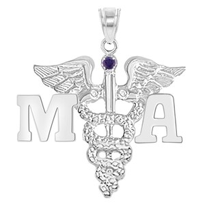 May include: Silver medical pendant with a caduceus symbol, wings, and a purple gemstone. The letters "MA" are on either side of the caduceus.