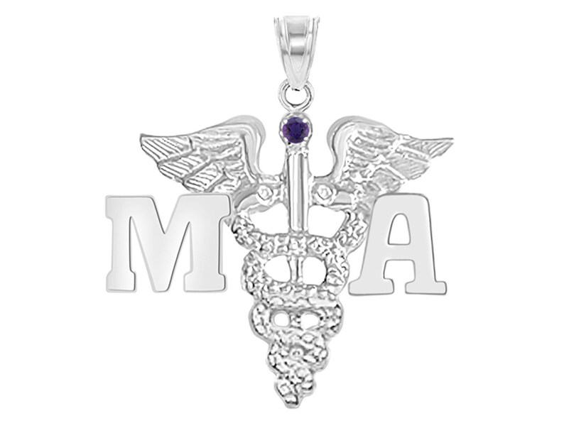 May include: Silver medical pendant with a caduceus symbol, wings, and a purple gemstone. The letters "MA" are on either side of the caduceus.