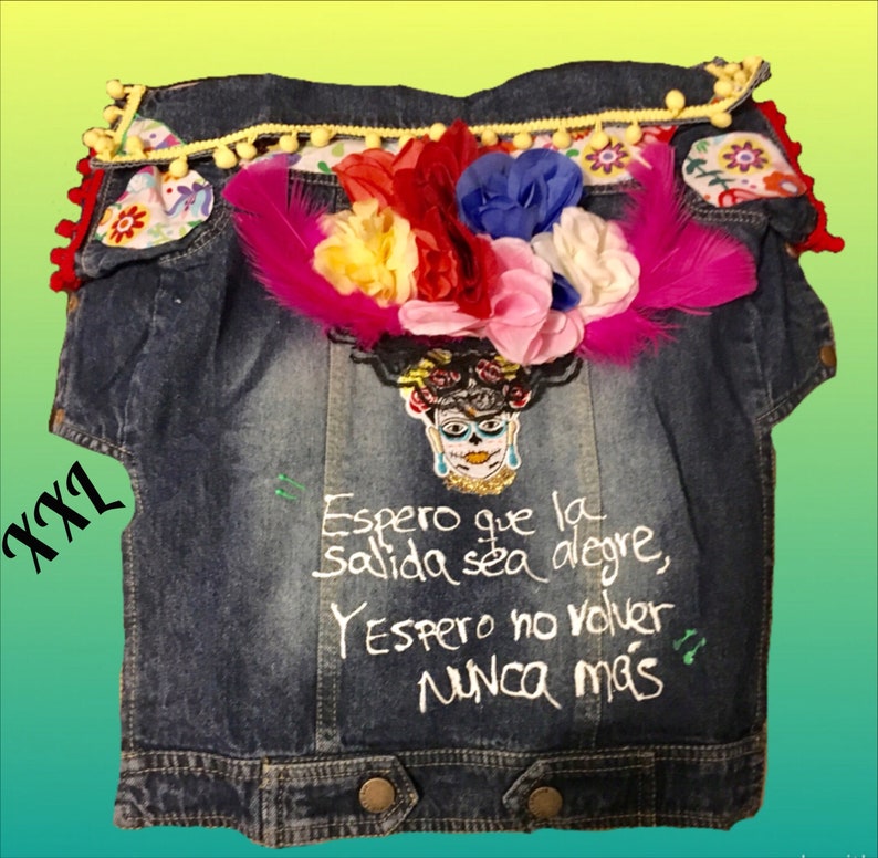 May include: A blue denim jacket with embroidered flowers, feathers, and a skull with a quote in Spanish that reads "Espero que la salida sea alegre, Y espero no volver nunca m&aacute;s".