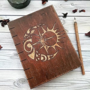 Wooden book for records with an engraving handmade,Notepad in a wooden cover,Wooden notebook with aged paper.