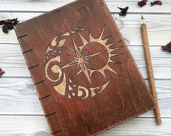 Wooden book for records with an engraving handmade,Notepad in a wooden cover,Wooden notebook with aged paper.