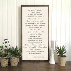 May include: A framed print with a white background and black text. The text is a quote by F. Scott Fitzgerald about the importance of making the best of things and having the courage to start over. The print is surrounded by a dark wood frame.