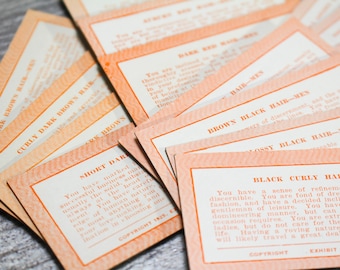 May include: A stack of orange and white cards with text describing personality traits based on hair color and style. The text on the top card reads "Dark Brown Hair-Men".