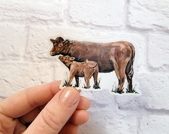 May include: A brown cow and calf sticker. The cow is standing with its head turned to the side, looking at the calf. The calf is standing next to the cow, looking up at the cow. The sticker is on a white brick background.
