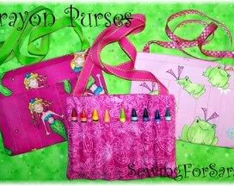 May include: Three colourful crayon purses with different patterns. Each purse has a zipped pocket and a strap for carrying. The purses are made of fabric and are decorated with various designs, including mermaids, frogs, and flowers.
