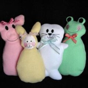 May include: Four plush stuffed animals: a pink pig with a pink bow, a yellow bunny with a yellow bow, a white seal with a blue bow, and a green frog with a red bow.