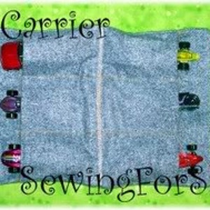 May include: Grey fabric car carrier with red handles and six slots for toy cars. The carrier is open and the slots are filled with toy cars. The text "SewingForSarah" is printed on the bottom of the carrier.