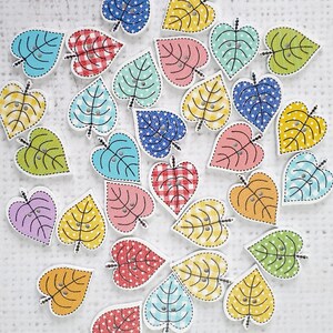 May include: Assortment of colorful wooden heart-shaped buttons with various patterns, including gingham, polka dots, and floral designs.