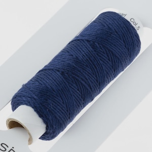 May include: A navy blue thread spool is shown on a white card. The thread is tightly wound. The card is labelled with the text "Col. 5". This thread is suitable for sewing, embroidery, or other textile crafts.
