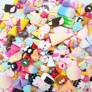 May include: A collection of colourful, miniature, resin food charms, including ice cream cones, popsicles, cupcakes, and other sweet treats. These charms are perfect for adding a whimsical touch to crafts, jewellery, and other projects.