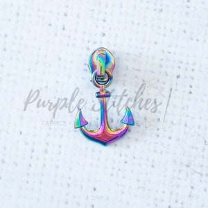 May include: A rainbow iridescent zipper pull with an anchor design. The anchor is a popular nautical theme.