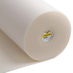 May include: A roll of white foam fabric with a yellow label that says "STYLE-VIL".