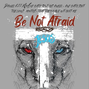 May include: A graphic design featuring a lion's face with one red and one blue eye, overlaid with a white cross and the words "Be Not Afraid" and "Jesus". The background is gray, and the text "Daniel 6:22" is at the top.