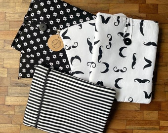 Sale; Tablet sleeve for 9,7 inch tablet like iPad 1 en iPad 2. Available in multiple black-and-white patterns, with button or zipper