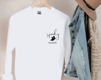 May include: White long-sleeved sweatshirt with the text "spooky season" and a ghost graphic.