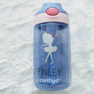 May include: A blue and pink water bottle with a straw and a ballerina design. The bottle has the name "FINLEY" and the brand name "contigo" printed on it.