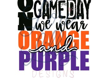 May include: A graphic design featuring the text ON GAME DAY we wear ORANGE and PURPLE. The word ON is in black, GAME DAY is in black, we wear is in black script, ORANGE is in bright orange, and PURPLE is in deep purple block lettering.