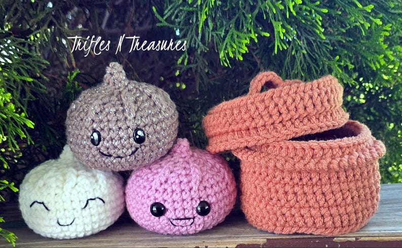 May include: Crocheted onion-shaped toys in white, pink, and tan, each with embroidered faces. A crocheted basket with a lid is also present. The text "Trifles N Treasures" is visible in the upper left corner.