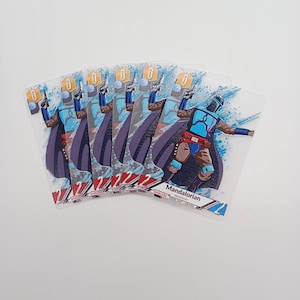 May include: A set of six identical trading cards featuring a Mandalorian character in blue and brown armour with a purple cape. The cards display the text Mandalorian, Shielded, and Token Unit Ground, with a blue splash graphic background.