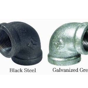 May include: Two 90-degree elbow pipe fittings, one black steel and one galvanized grey.