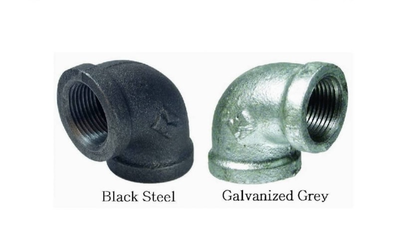 May include: Two 90-degree elbow pipe fittings, one black steel and one galvanized grey.