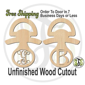 May include: Unfinished wooden cutout of a baby rattle with a circle for a monogram. The rattle is shown twice, once with the monogram "C" and once with the monogram "B".