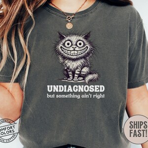 Undiagnosed Something Aint Right Funny Cat Meme Shirt, Ironic Shirt, Weirdcore Clothing, Graphic Tee, Unhinged Cursed Frazzled Cat Caffeine