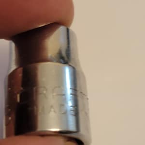 May include: Close-up of a silver socket wrench with the text "Craftsman Made" engraved on the side.