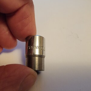 May include: A silver socket wrench with the text "CORNWELL" and "7/16" engraved on the side.