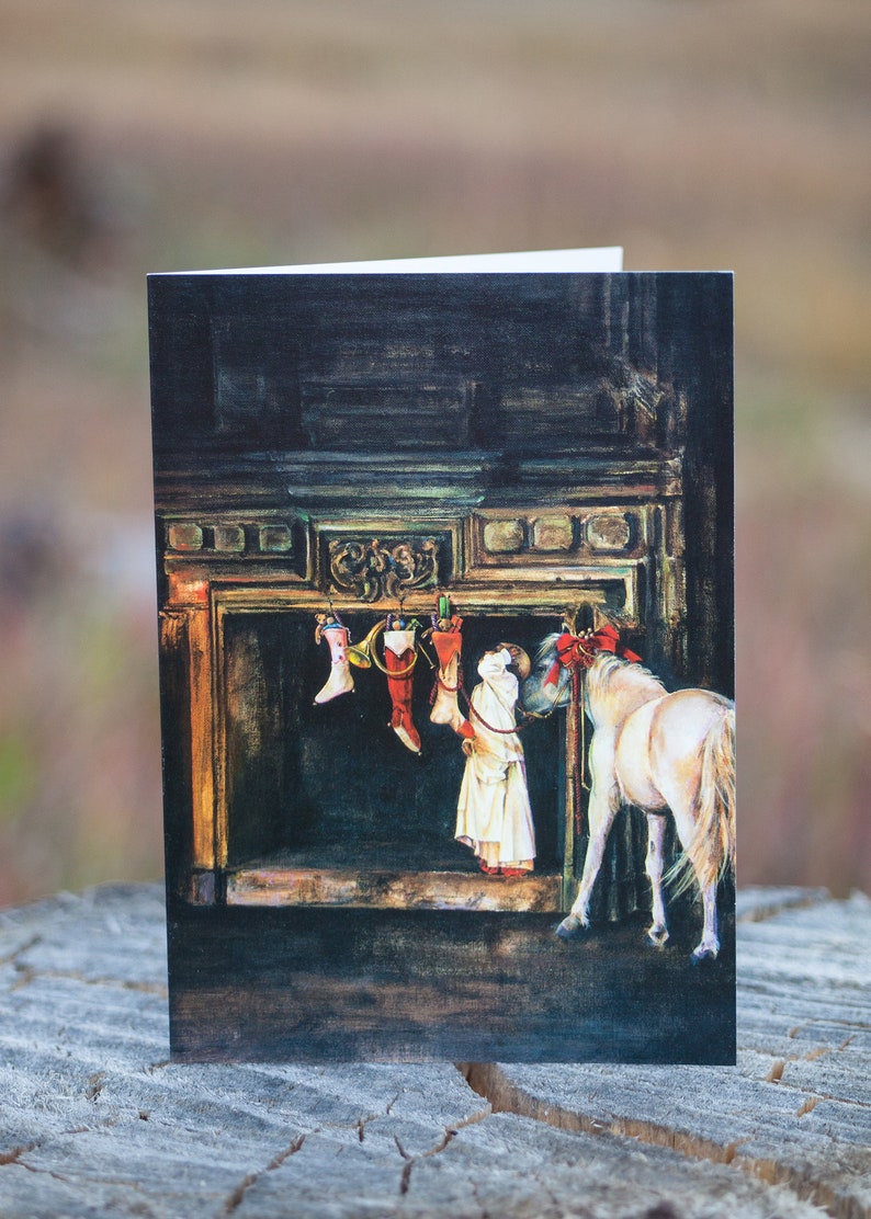 May include: A white horse with a red bow stands in front of a fireplace with stockings hanging from the mantle. The stockings are filled with toys and gifts. A person in a white dress is standing next to the horse, looking at the stockings.