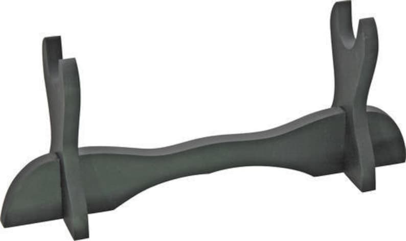 May include: A black wooden sword stand with two slots for holding swords. The stand is curved in the middle and has a flat base.
