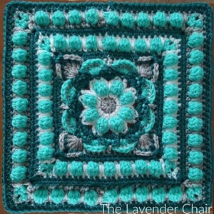 May include: A teal, white, and gray crochet square with a floral design in the center. The square has a textured border with raised bumps.