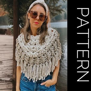 May include: A beige crochet poncho with fringe detail. The poncho is worn over a white top and blue jeans. The word "PATTERN" is written vertically in white on a black background.