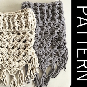 May include: Two crocheted scarves with fringe, one in beige and one in gray. The scarves are made with a textured stitch and have a triangular shape.